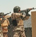 Iraqi Army cover their fellow soldiers as they search