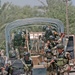 Iraqi Army jump out of a truck to search a house