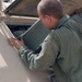 Pfc. Zachary Watson checks the air filter on a M1064