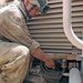 Spc. Aybar tightens a hose on the final drive assembly