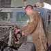 Spc. John Harris works on a Humvee in the maintenance area