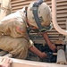 Spc. Aybar tightens a hose on the final drive assembly