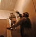 Scouts check the roof of a house during a raid