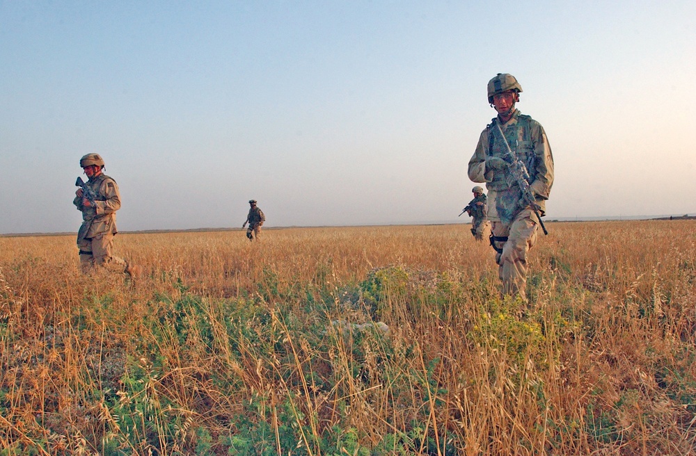 SSgt. Fritz Autenrieth leads Soldiers across a field