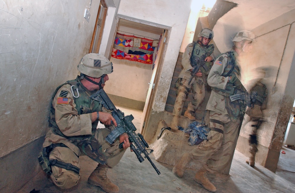 Staff Sgt. Joshua Cardinal watches his team members quickly move