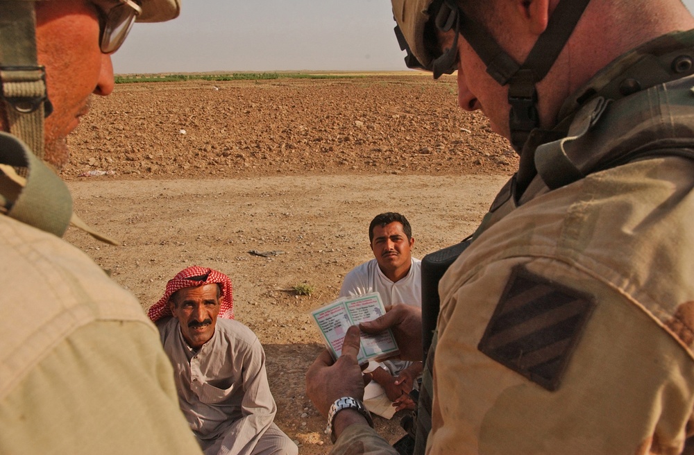 Staff Sgt. Joshua Cardinal check the weapons cards