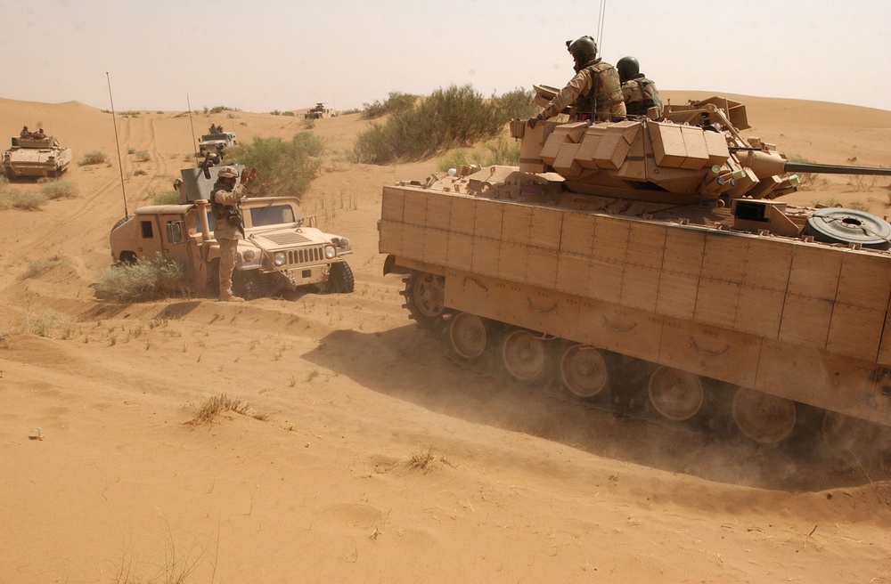 Scouts travel through the austere desert environment