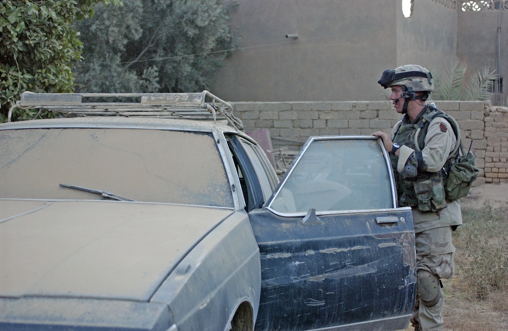 Sgt. Pete Pinnel inspects a car in for any possible weapons