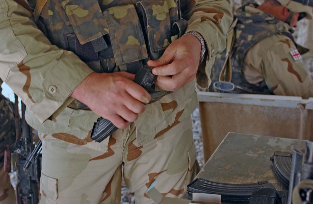 A soldier loads his magazine in preparation