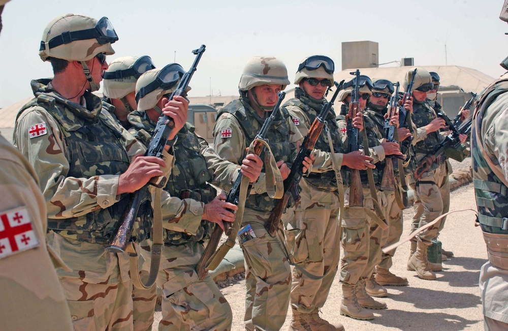 Soldiers check their rifles during guard mount