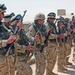 Soldiers check their rifles during guard mount