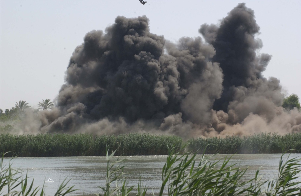 Debris flies into the air after a 500 pound bomb dropped