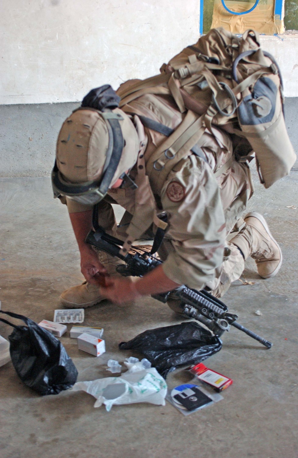 A Soldier searches through medical supplies