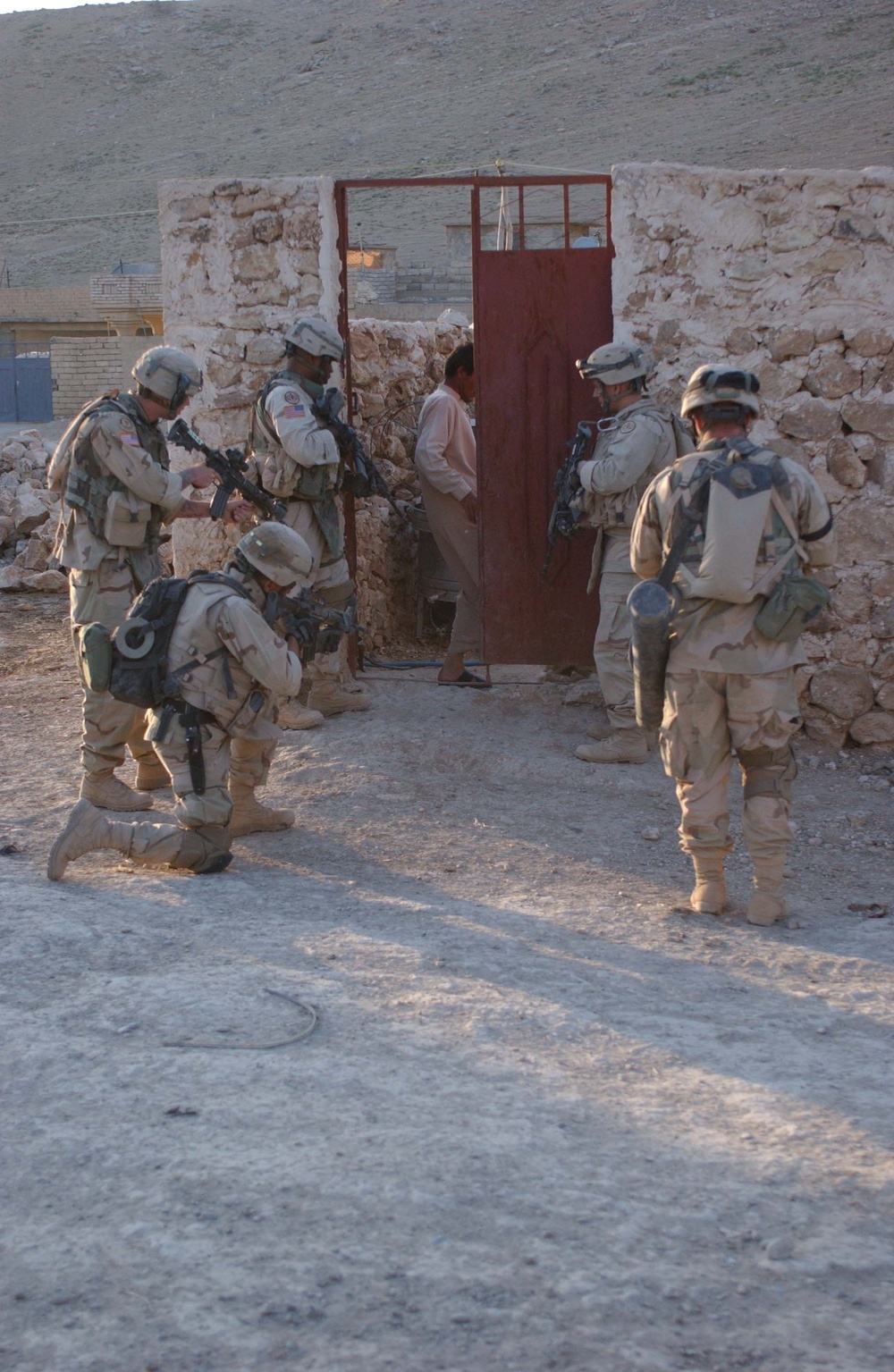 Soldiers stack outside the doorway