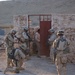 Soldiers stack outside the doorway