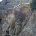 Soldiers search through a series of small caves