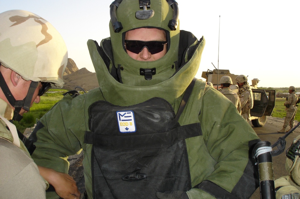 Staff Sgt. Dave Baker dons an EOD8 bomb suit