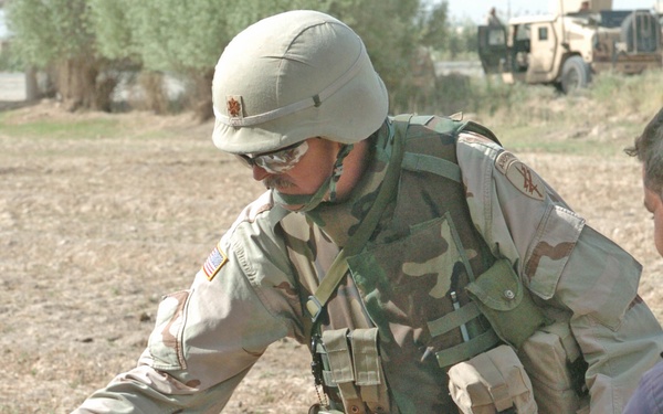 Maj. Scott vaccinates a cow against worms