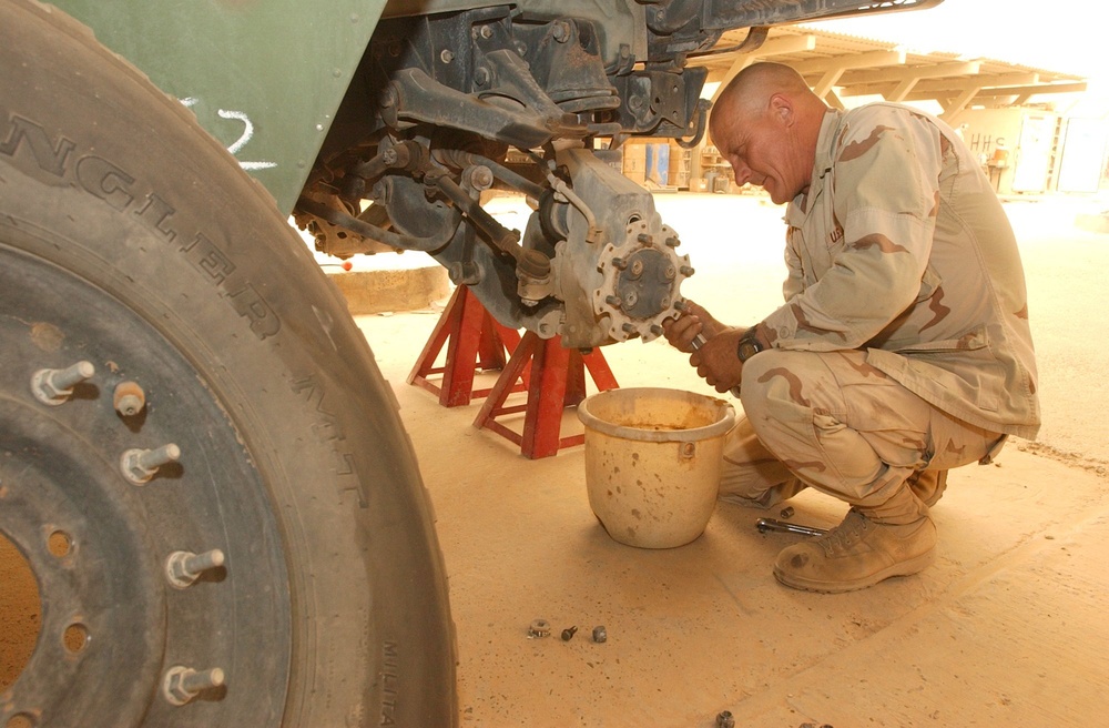 Sgt. Arthur Coogan makes repairs on a company vehicle