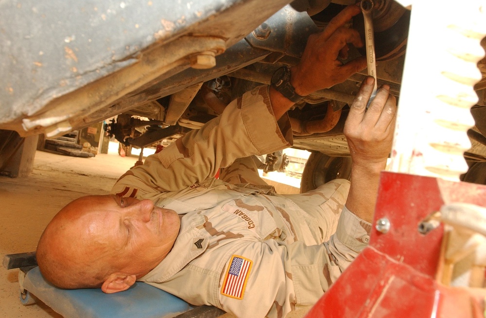 Sgt. Arthur Coogan makes repairs on a company vehicle