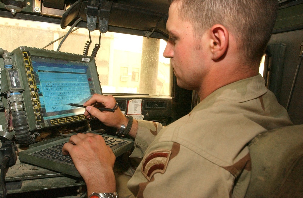 Spc. Jerome DeFrank programs the Blue Force Tracker