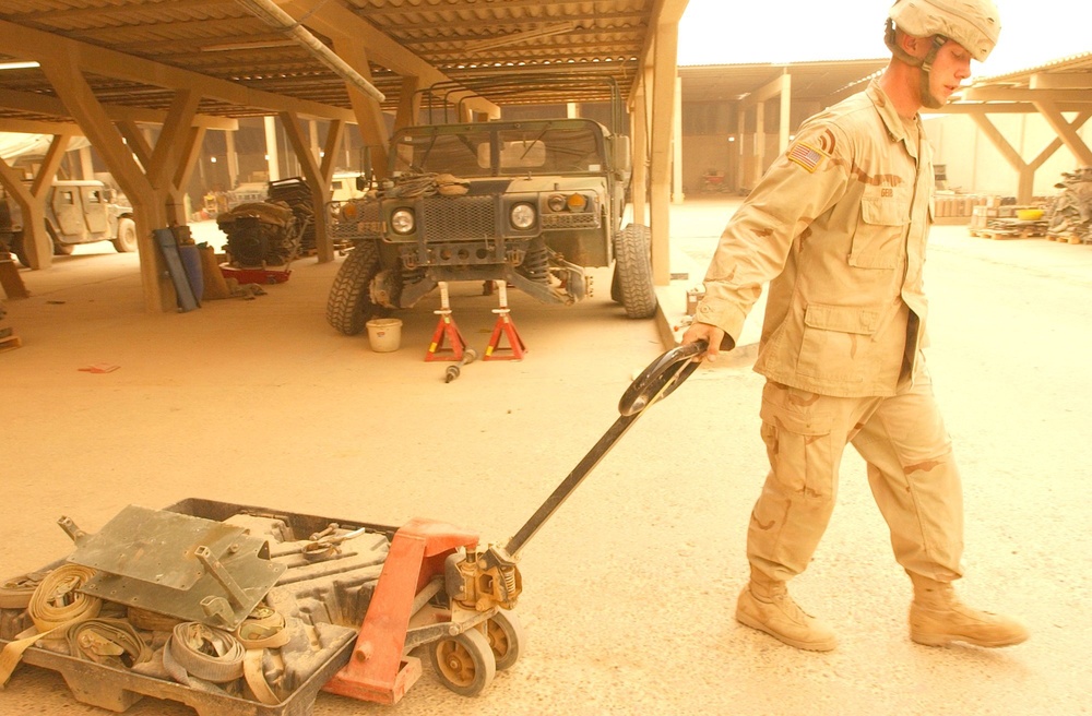 Pv2 Kenneth Geib pulls a skid lift during a routine clean-up