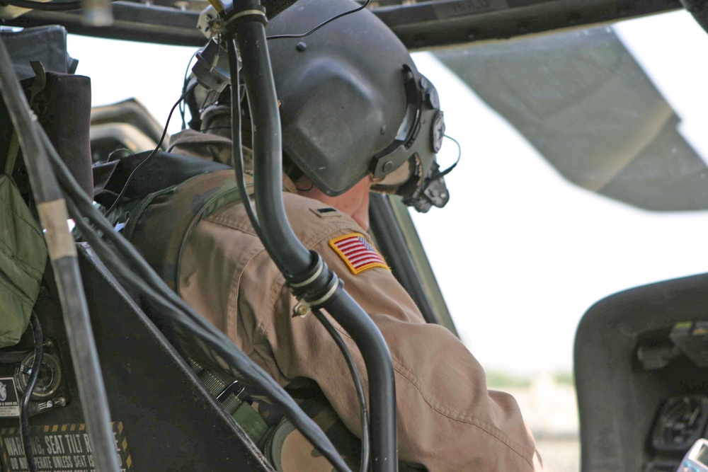 1LT Joshua Ingram buckles into his UH-60 Blackhawk