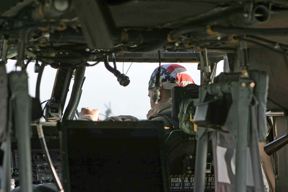 CW2 James Gisclair gets strapped into his UH-60