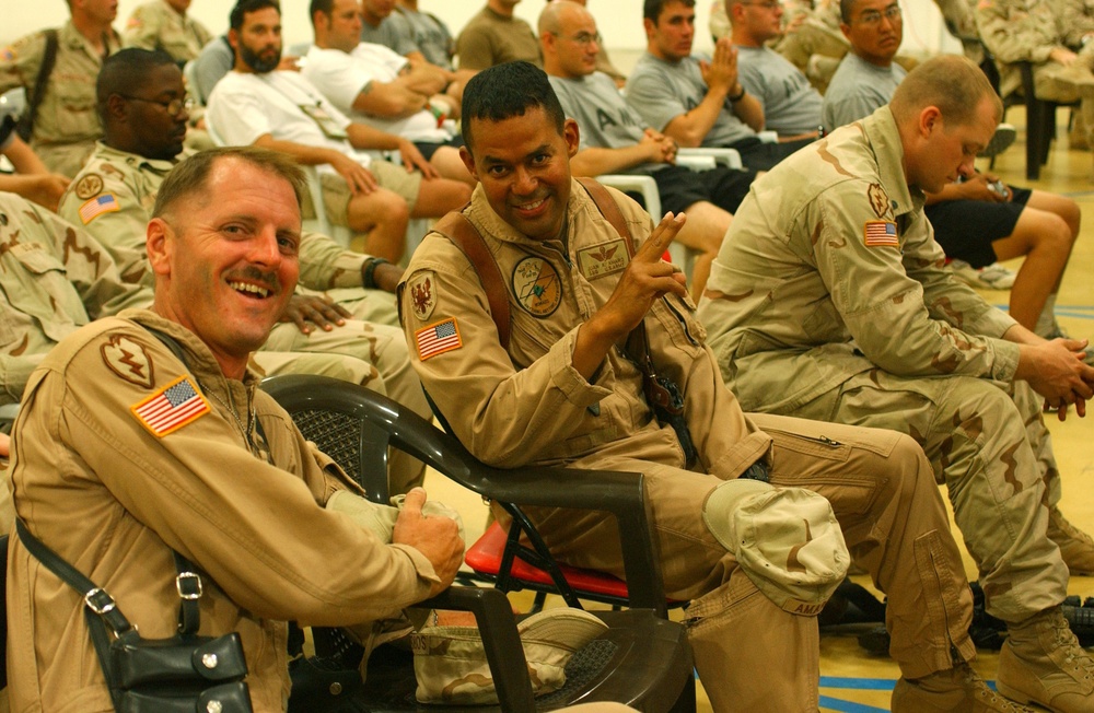 Soldiers smile for the camera at cheerleader show