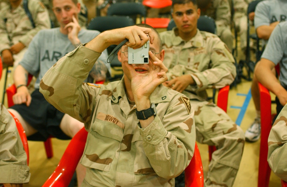 Soldier is happy to take a photo of the cheerleaders