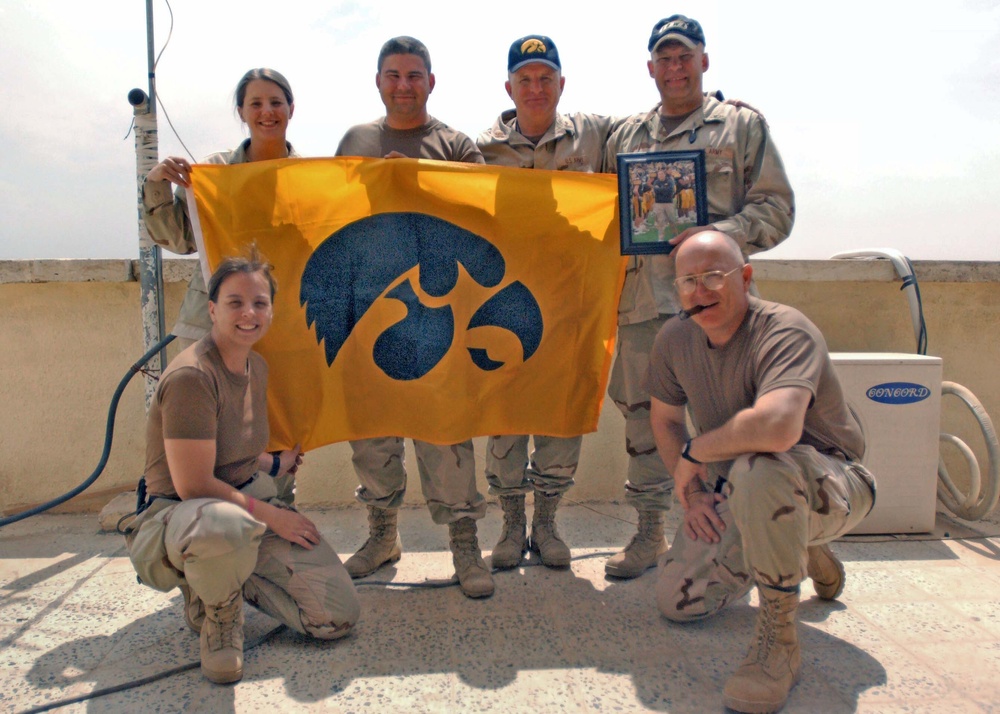 Soldiers show off an autographed Iowa Hawkeye  picture