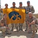 Soldiers show off an autographed Iowa Hawkeye  picture