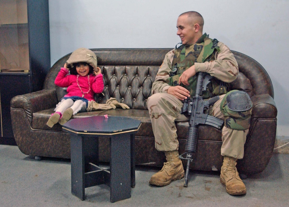 A Soldier makes a new friend in Mosul.