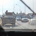 An American hummer convoy drives past an Iraqi Police