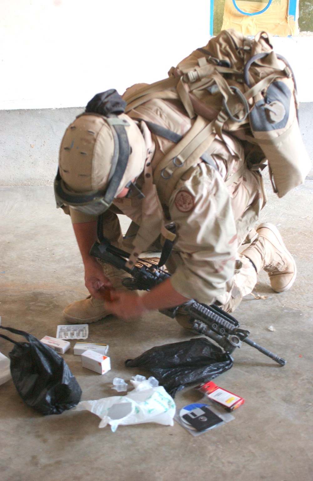 A 3rd ACR Soldier searches through medical supplies.