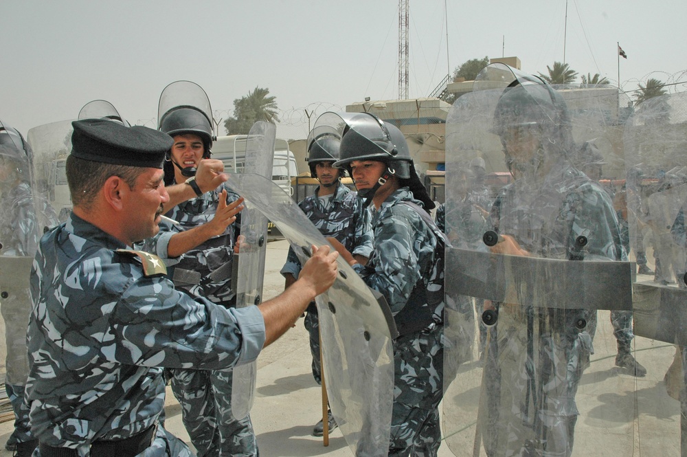 A instructor pulls on the front of the shield demonstrating
