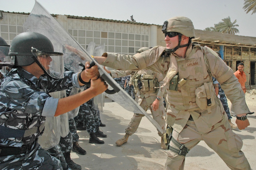 Spc. Nicholas Drumm throws punches at the shields