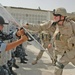 Spc. Nicholas Drumm throws punches at the shields