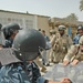 Spc. Nicholas Drumm pulls down the front of a shield