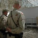 Military police officers stand in a formation outside