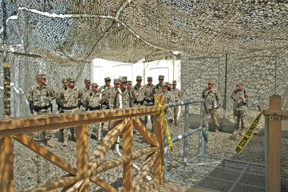 Military police officers stand in a formation outside