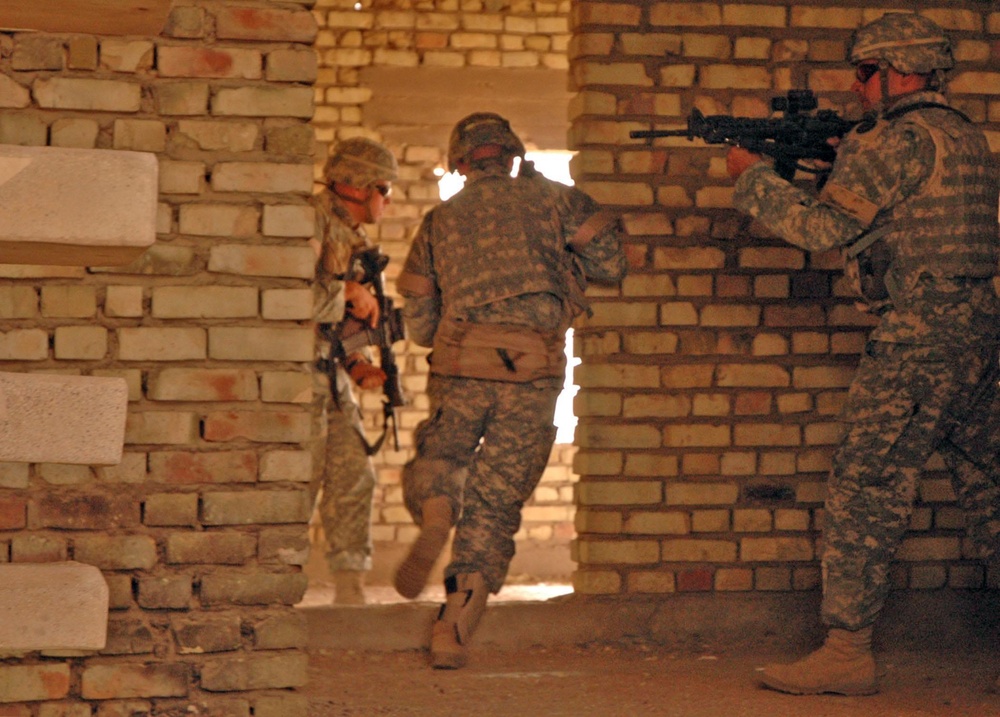 Soldiers clear a building room by room