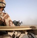 An Iraqi truck gunner mounted on top of a 2nd MTR truck unloads a belt of a