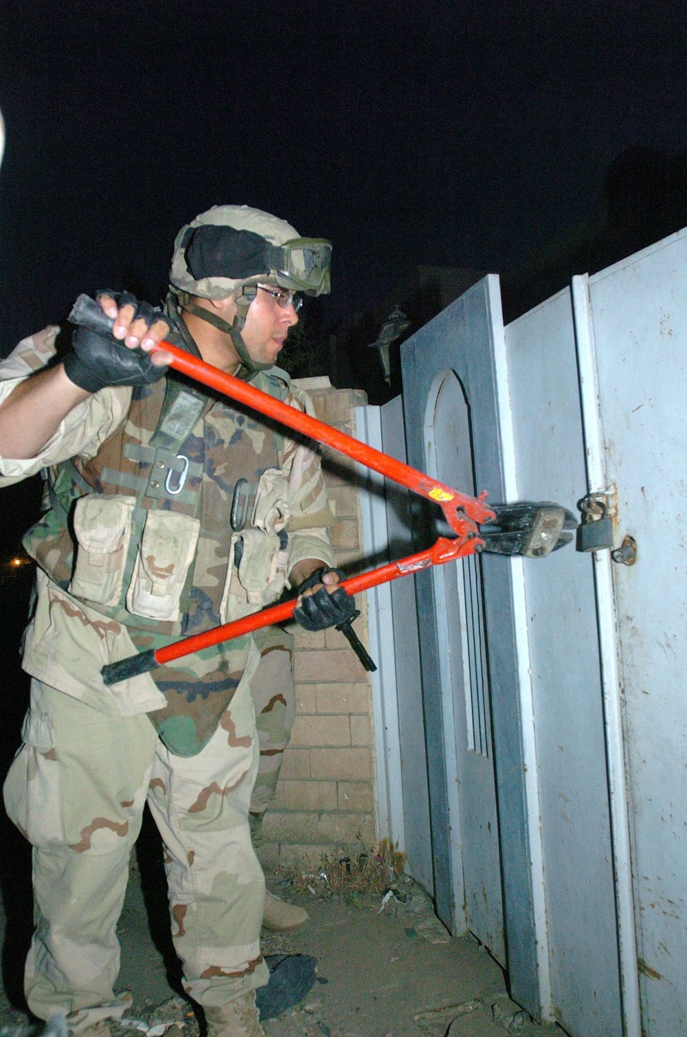 SPC Gonzalez cuts a padlock during a search