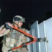 SPC Gonzalez cuts a padlock during a search