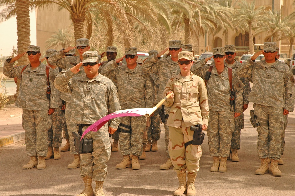 Soldiers stand at present arms during a Transfer of Authority