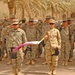 Soldiers stand at present arms during a Transfer of Authority
