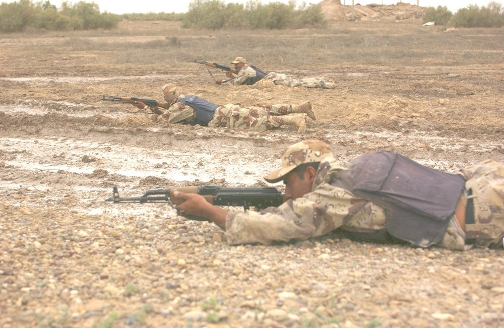 Iraqi army soldiers lay down in the prone position