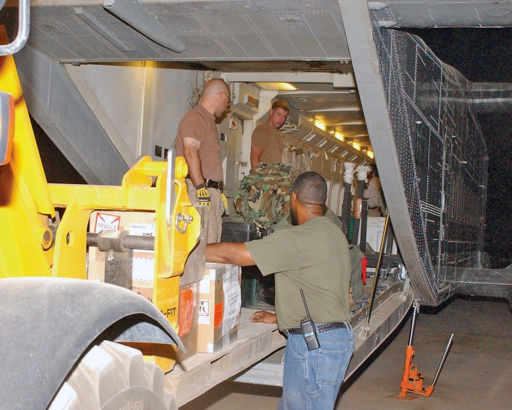 The Army and KBR work together to load a Sherpa