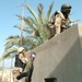 Troops climb onto a roof